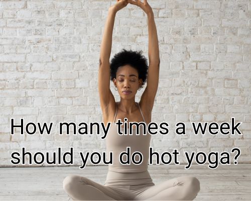 Woman in mid-pose during Bikram yoga class.